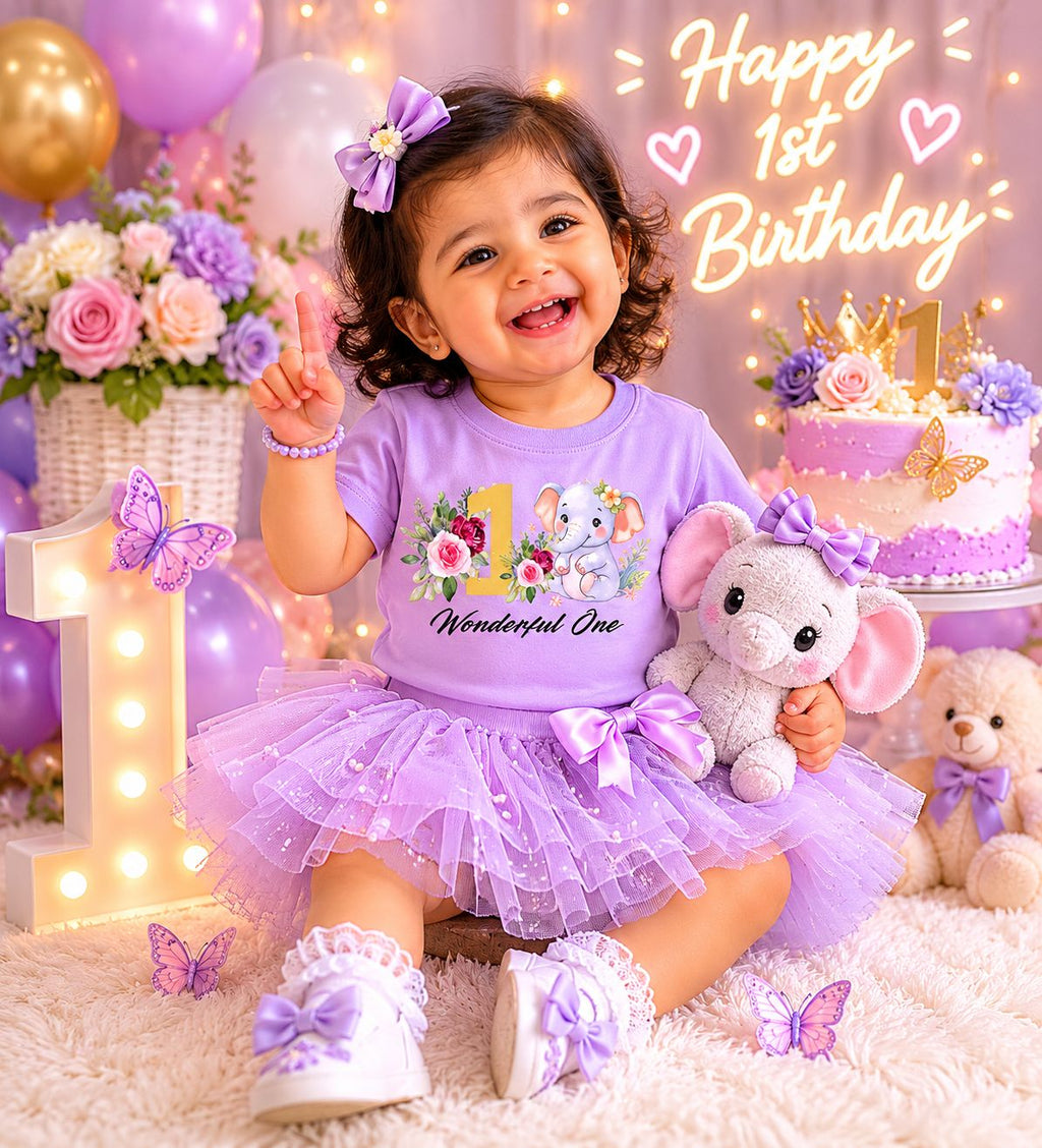 Baby girl wearing Iris Lavender Wonderful One Elephant first birthday shirt at her party